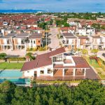 Aerial view of a master-planned residential community in Cebu with modern homes, clubhouse, and recreational amenities.
