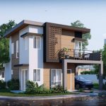 Modern two-storey house with balcony and carport in a master-planned residential community.