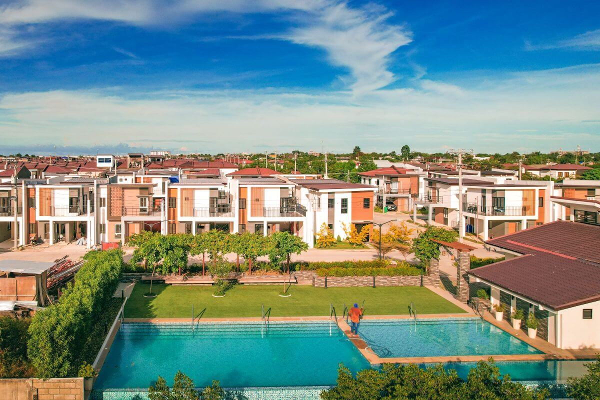 Modern residential community with swimming pool, clubhouse amenities, and contemporary family homes in Cebu.